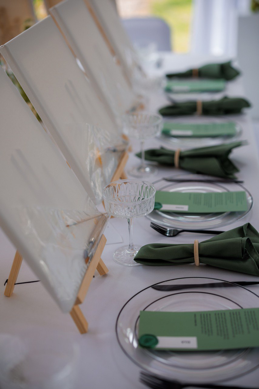 Vintage green baby carriage filled with white hydrangeas as baby shower decor