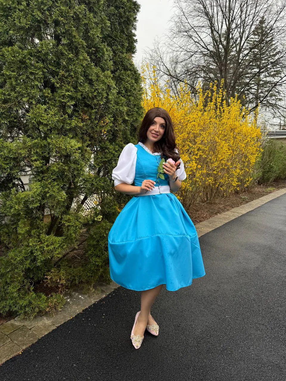 Princess Belle entertainer posing outdoors in a blue dress