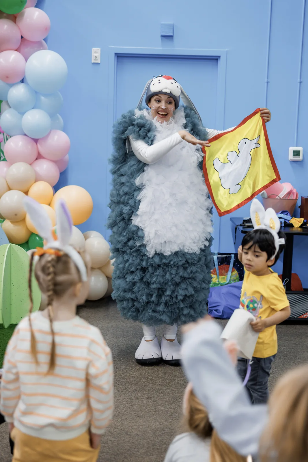 Bunny character entertainer performing for children at an Easter-themed event