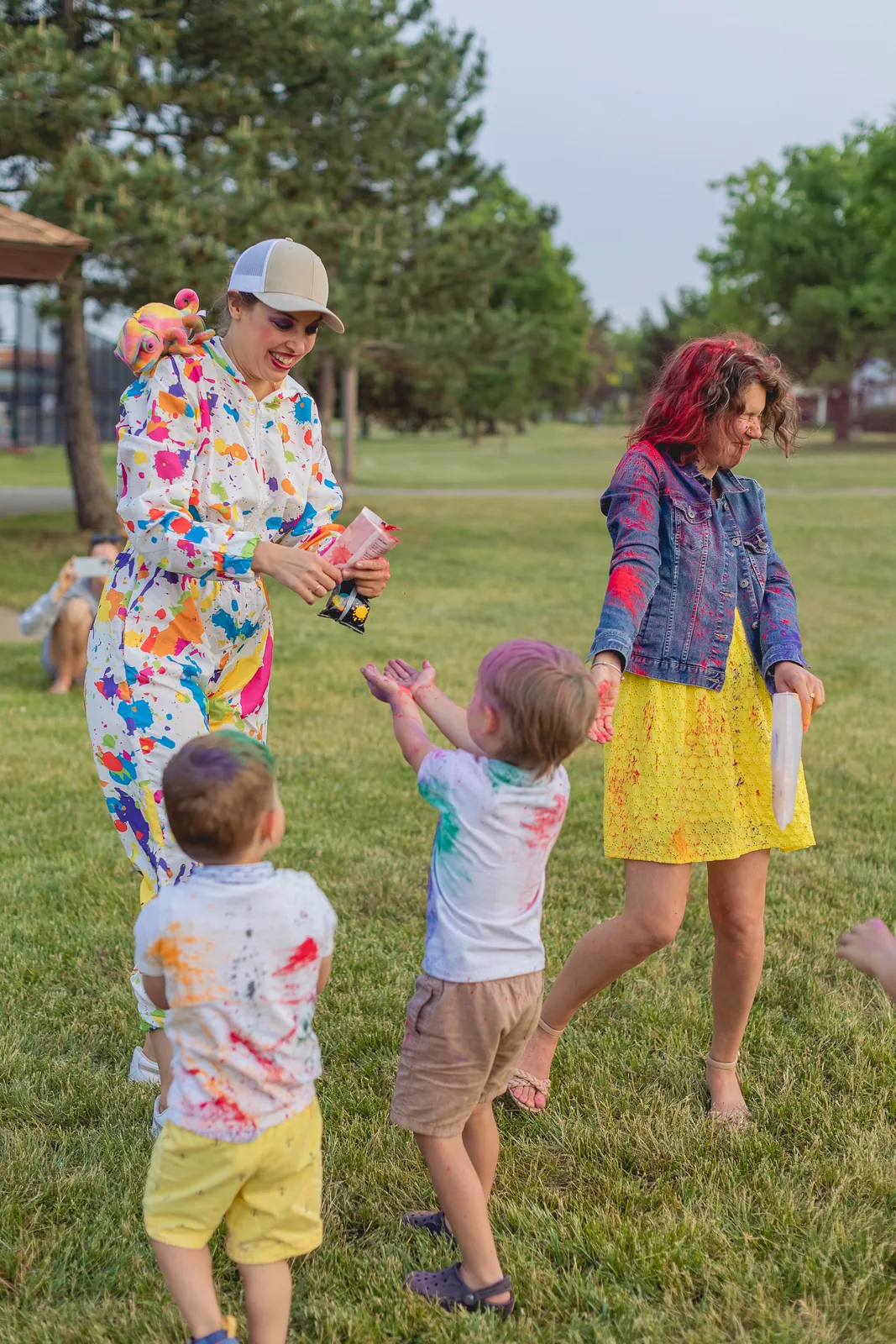 Entertainer handing out color powder to kids at a fun outdoor event