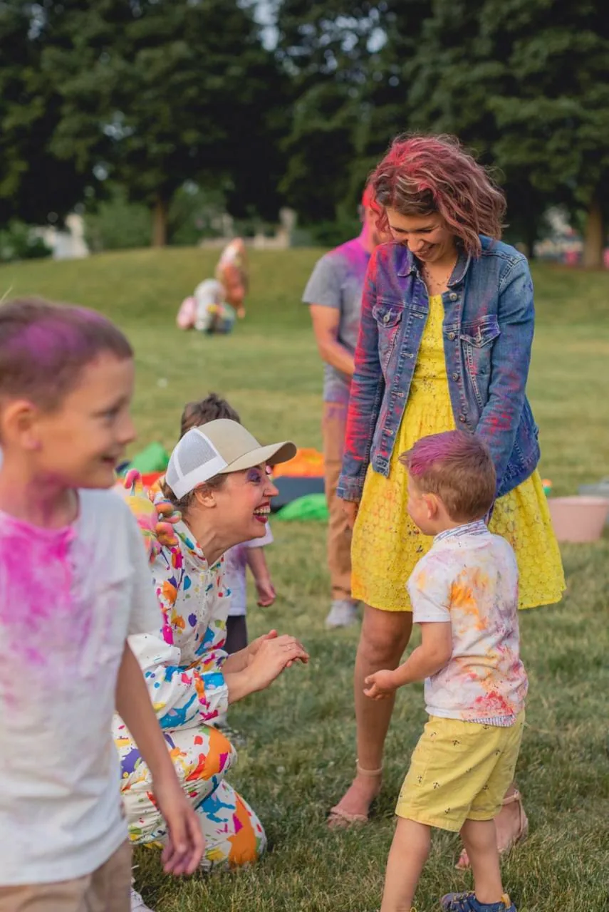Kids playing with colorful powder during an outdoor party