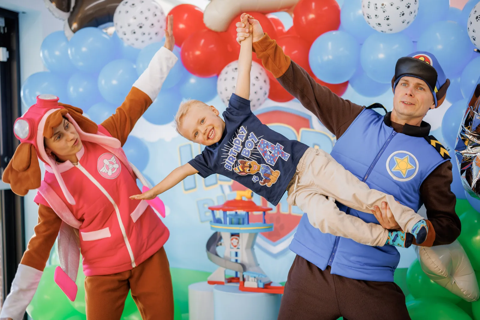 Paw Patrol Chase and Skye entertainers holding a child during a birthday party