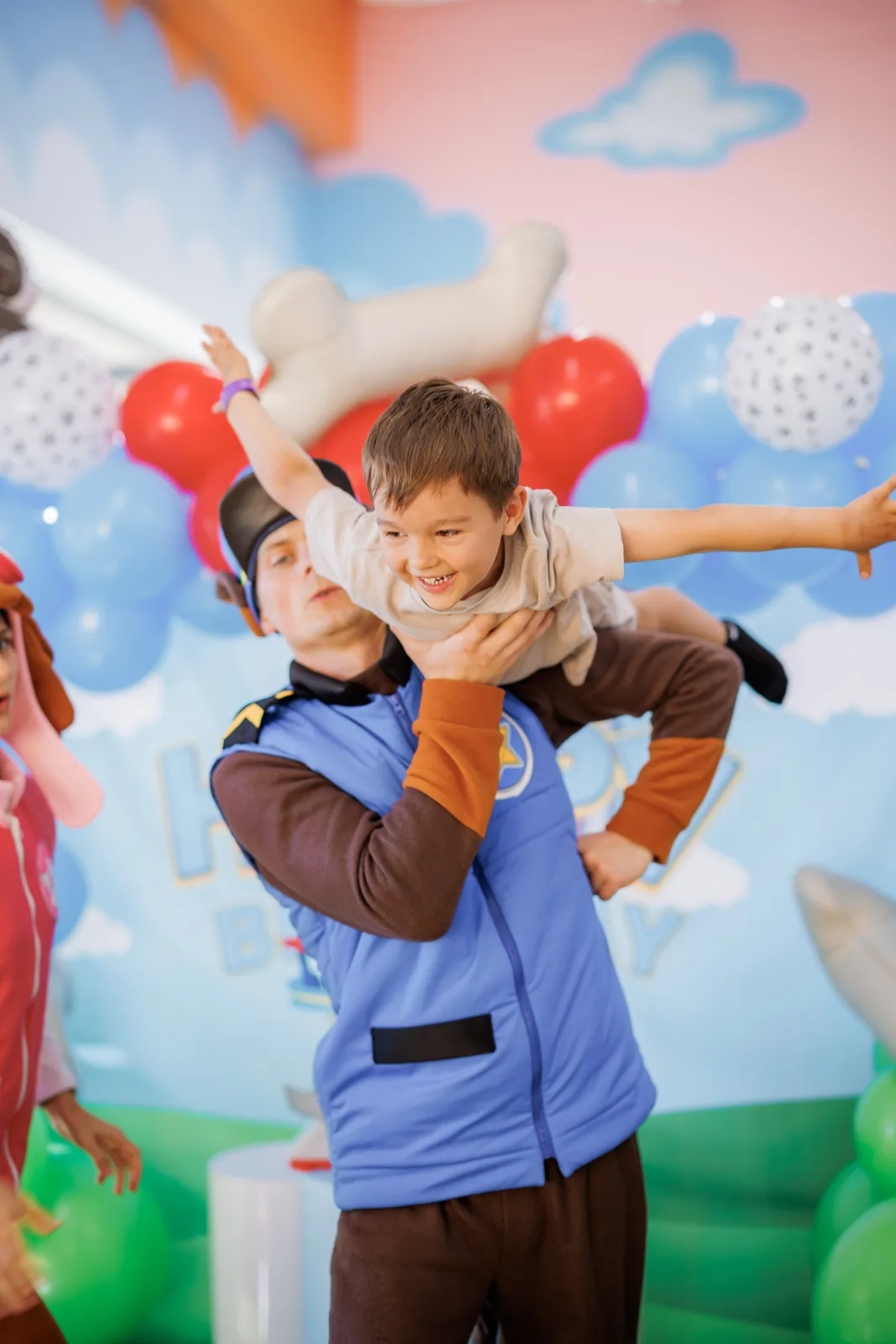 Child lifted in the air by a Paw Patrol Chase costumed entertainer