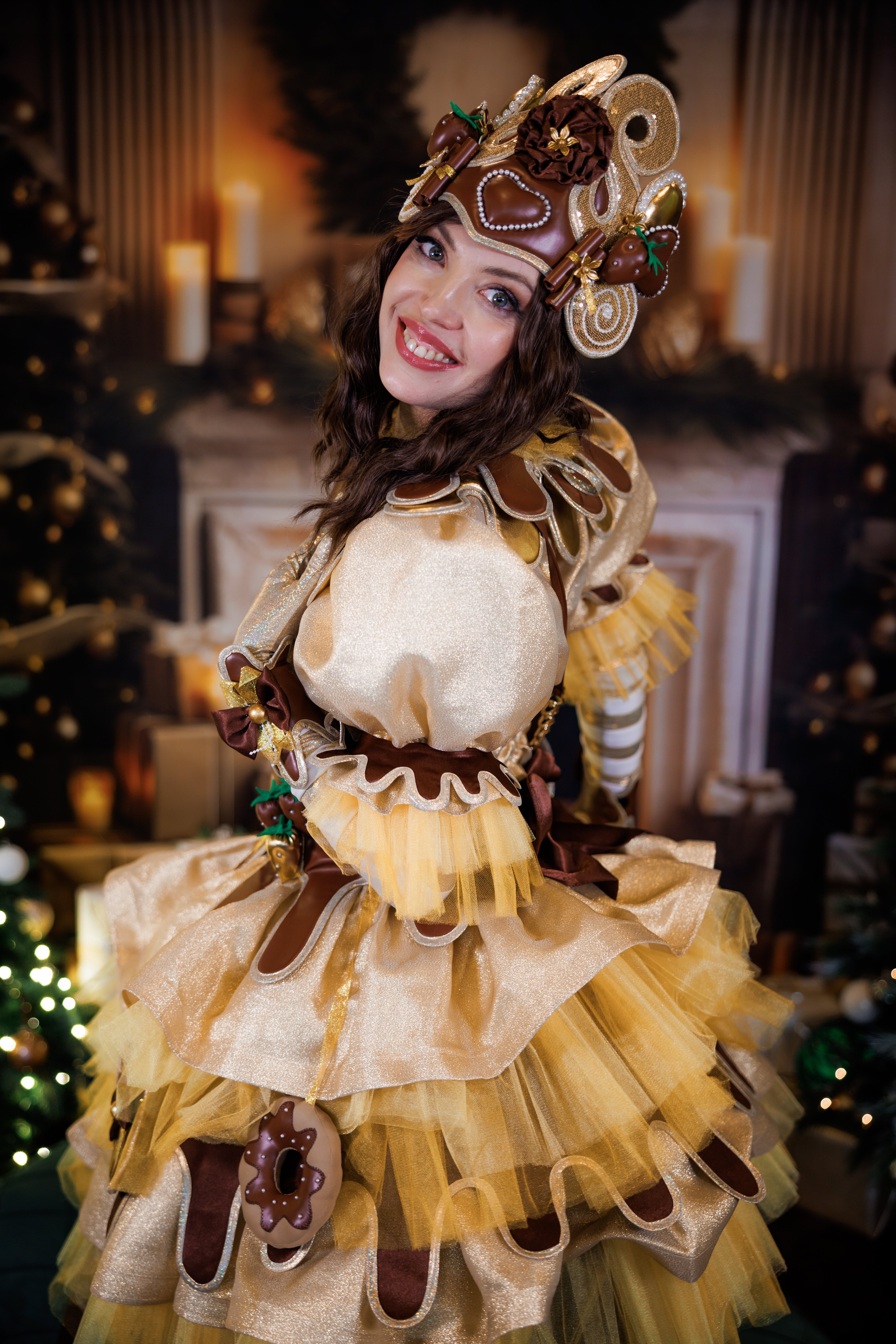 Chocolate fairy entertainer in a golden costume posing at a holiday event
