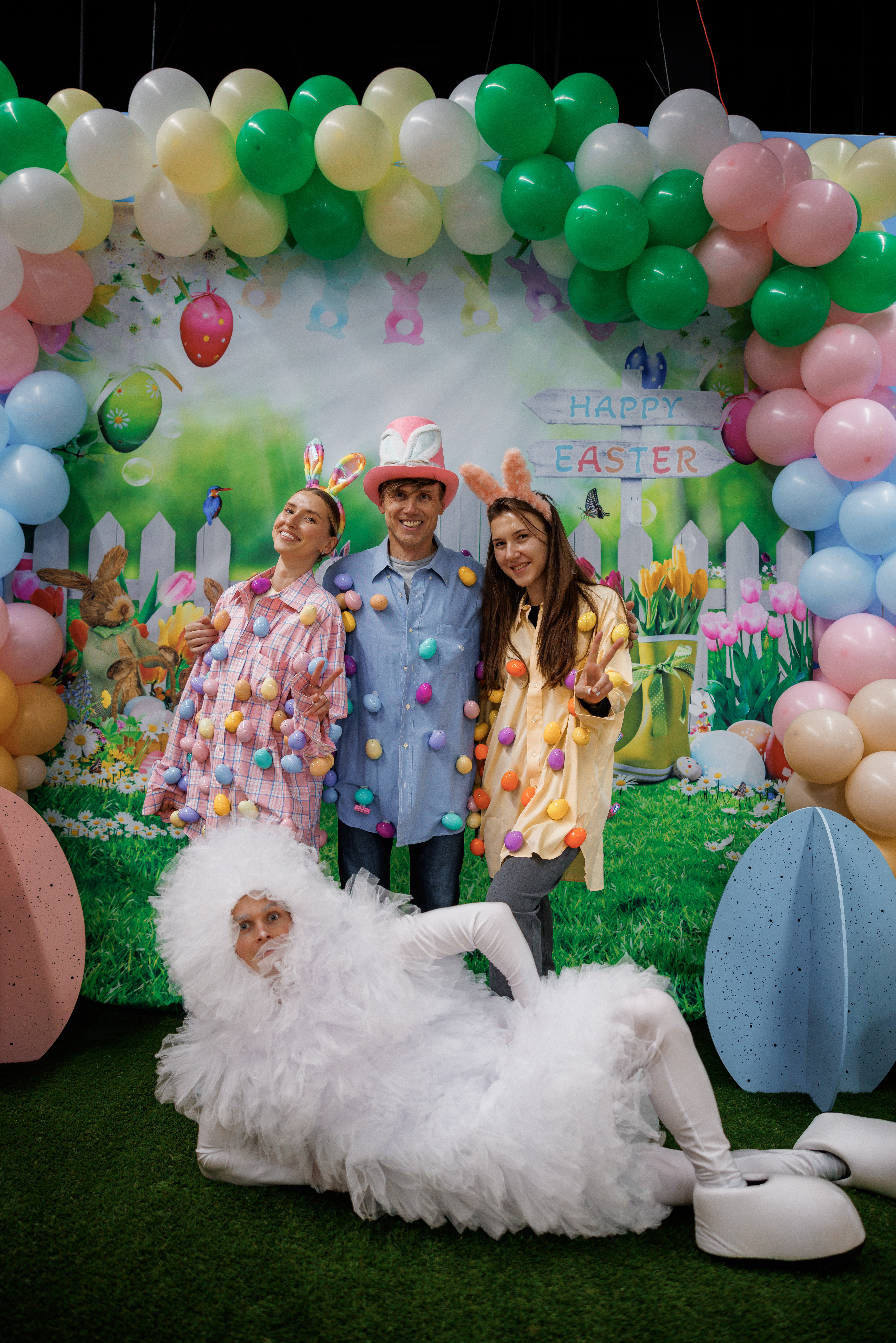 Group of Easter entertainers posing with a festive balloon backdrop