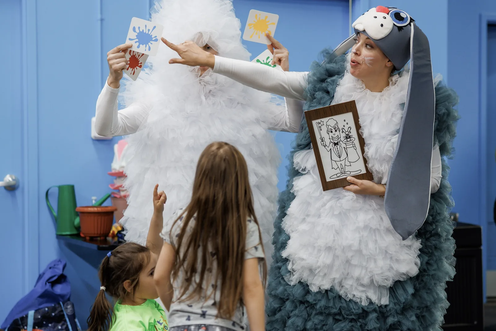 Easter-themed performers entertaining children with a card game