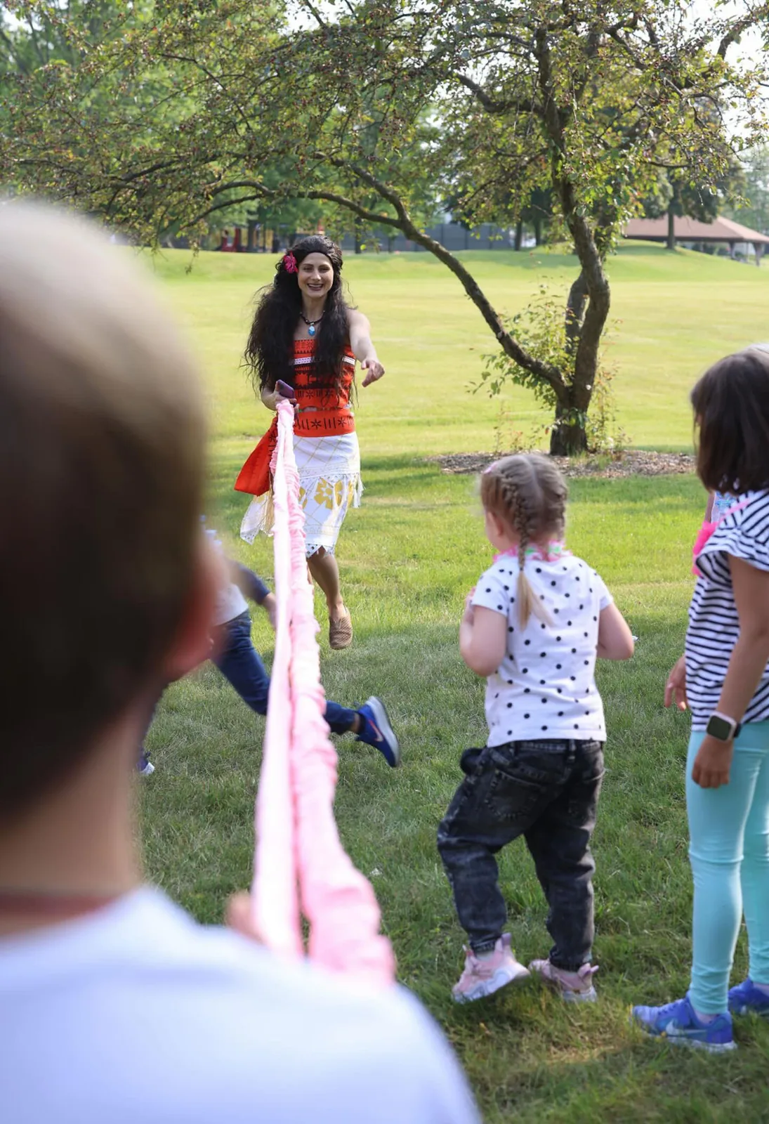 Moana character entertainer running interactive rope game at a kids outdoor party