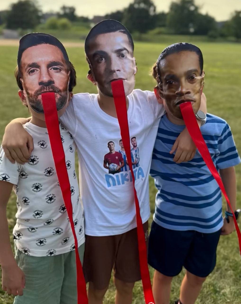 Kids wearing soccer star masks and hugging during themed party