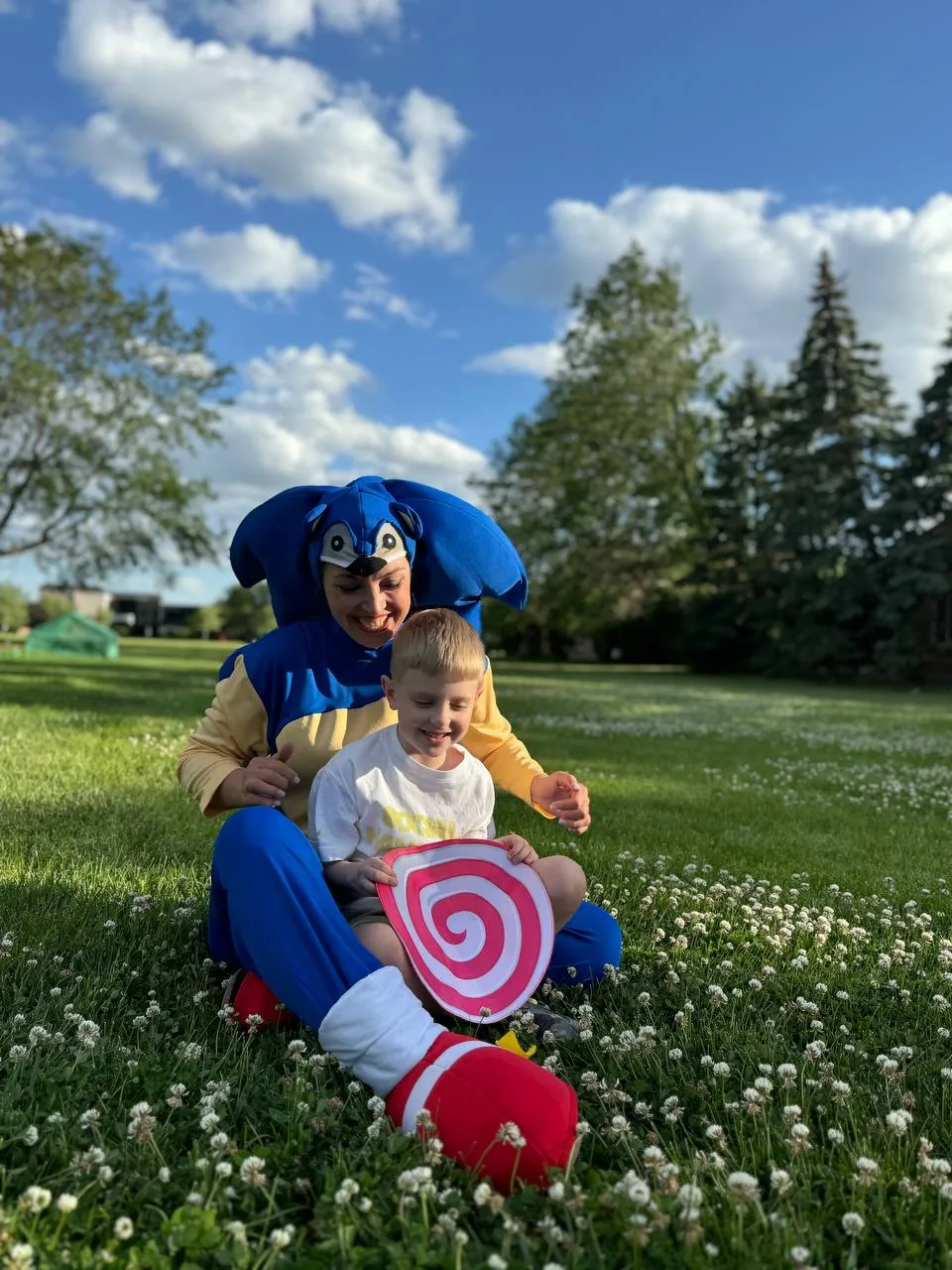 Sonic playing with child outdoors at family event