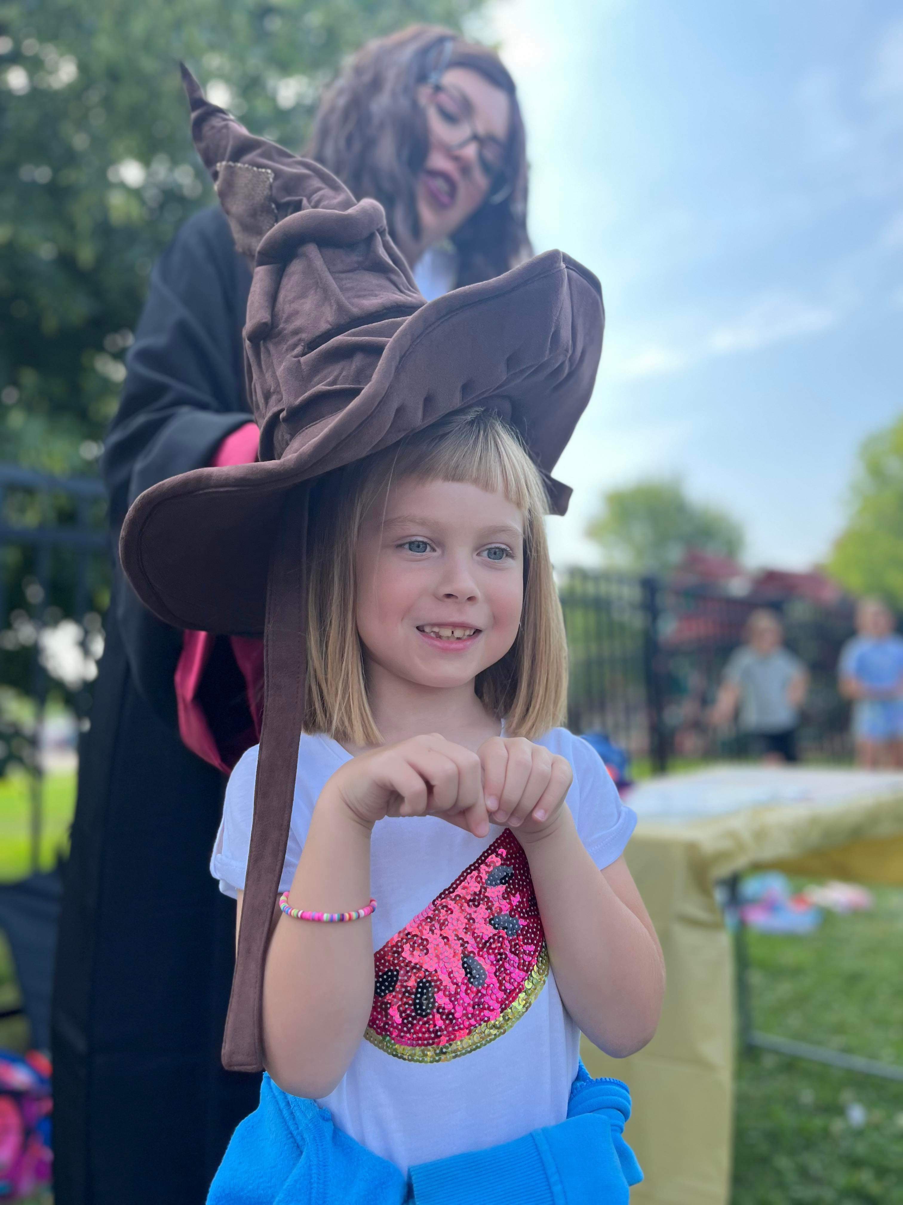 Kids pointing their magic wands at a wizard entertainer during a show