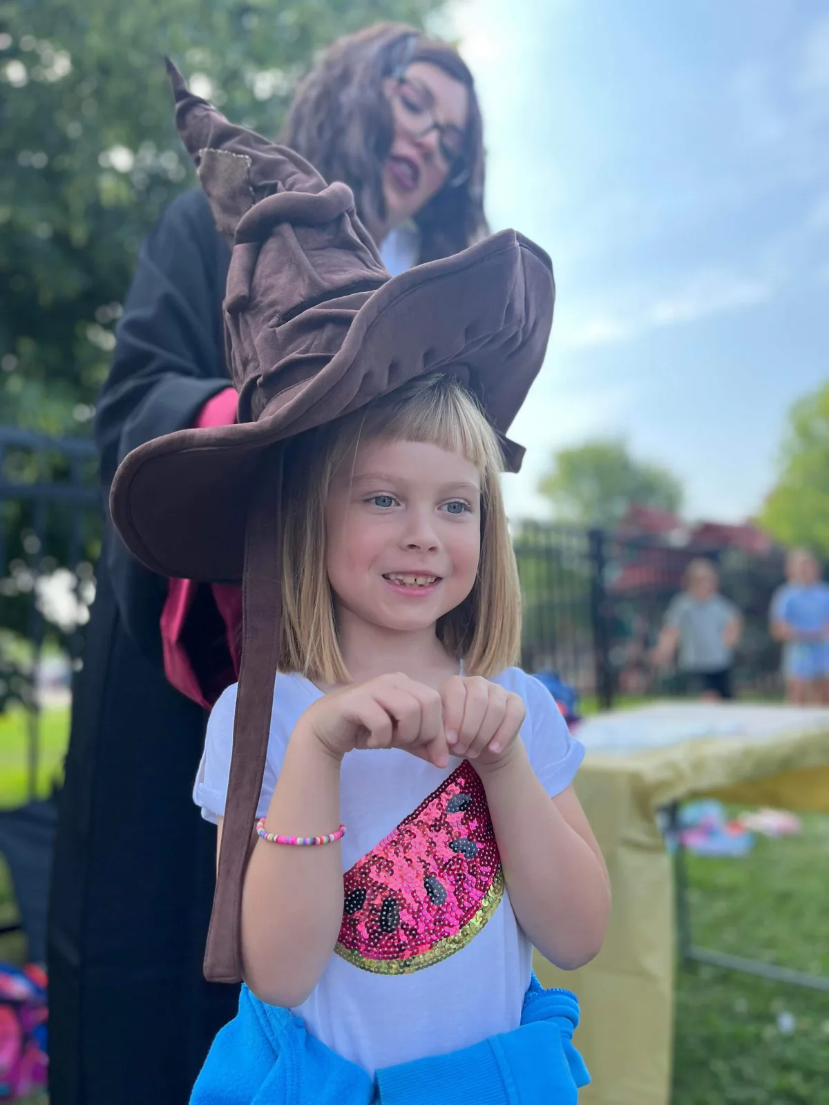 Kids pointing their magic wands at a wizard entertainer during a show