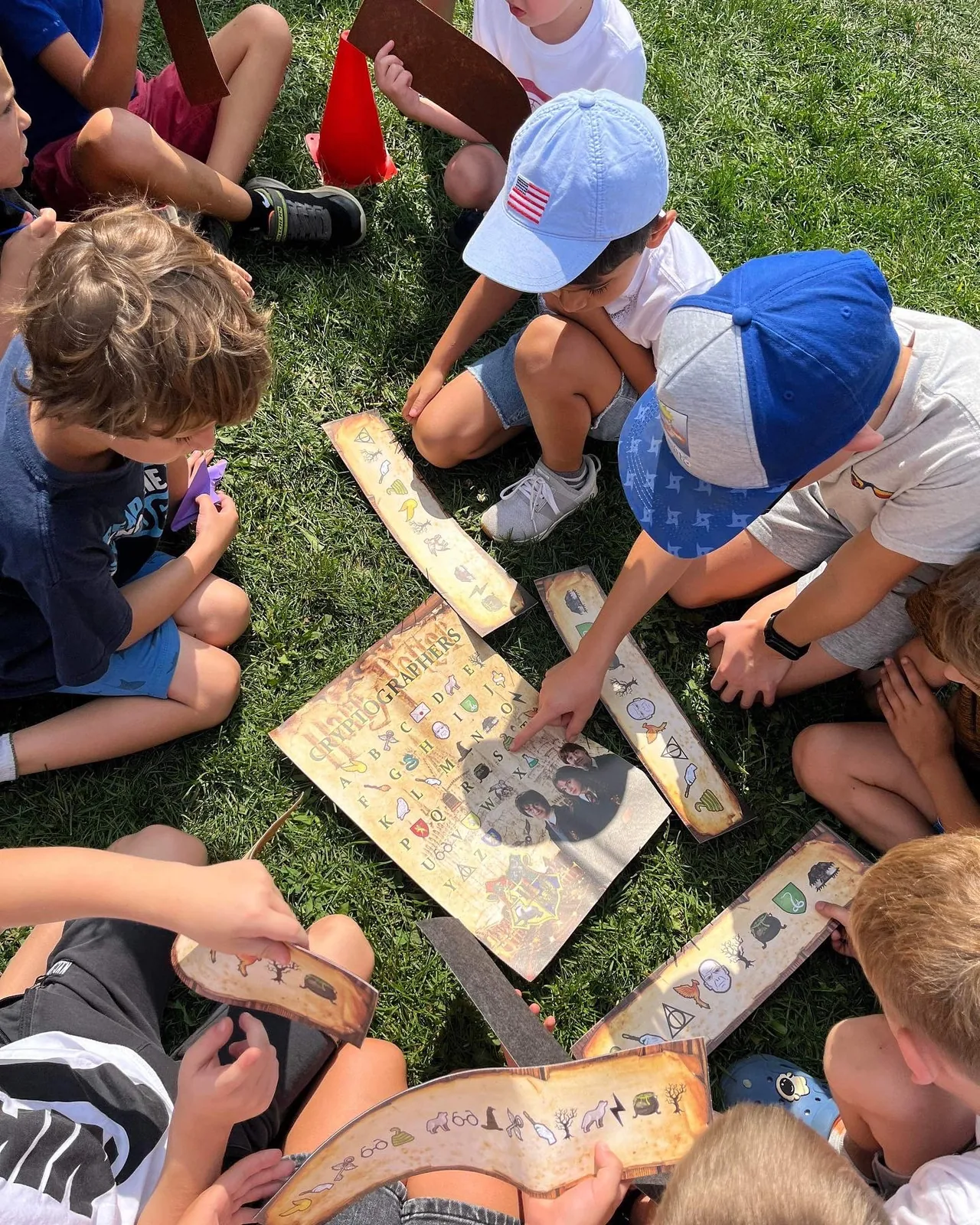 Children solving a wizard-themed puzzle outdoors