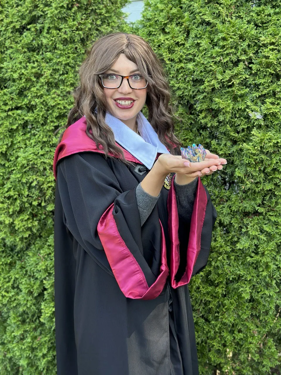 Wizard-themed entertainer holding magical props at a kids party
