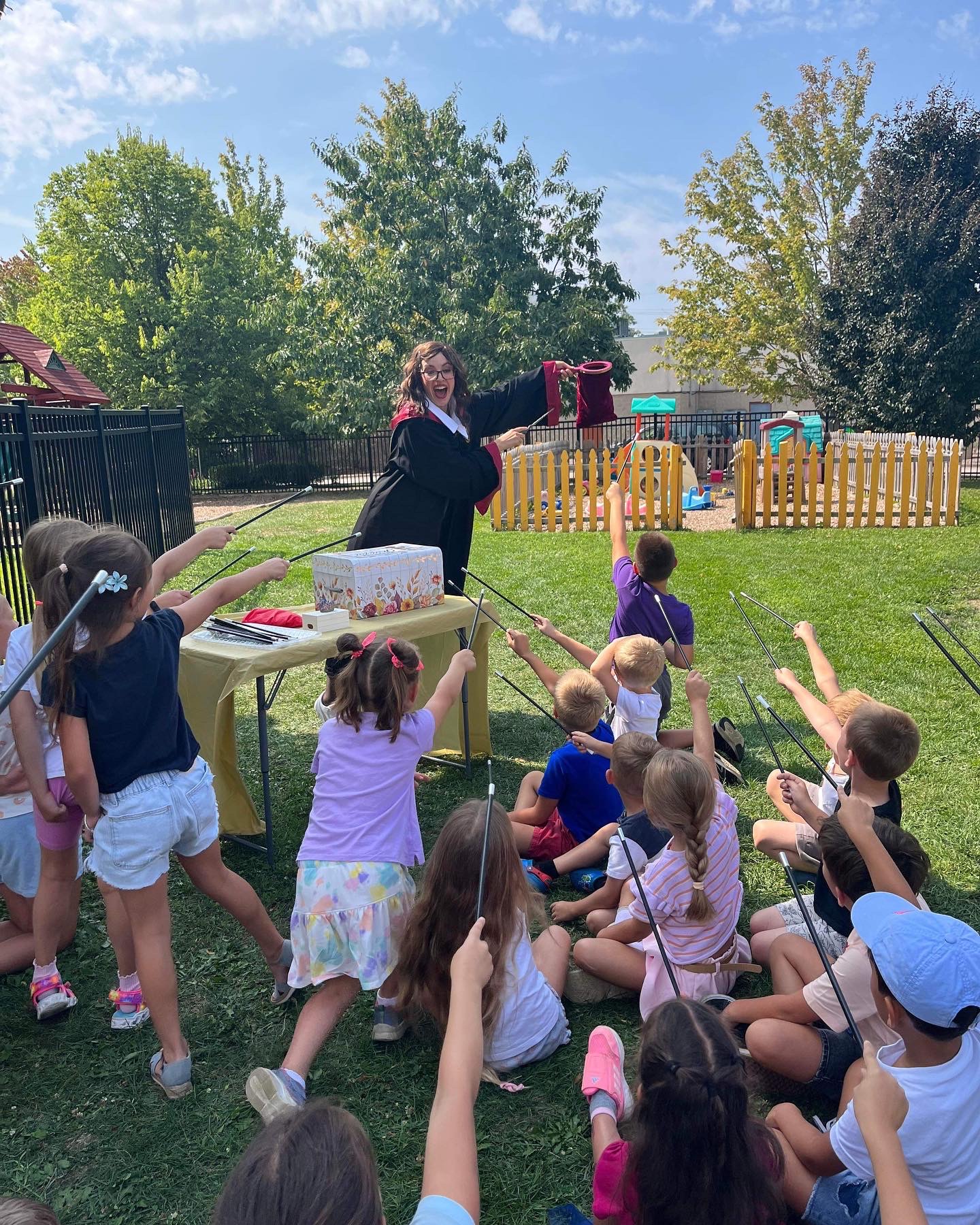 Children playing a wizard-themed game with a costumed entertainer