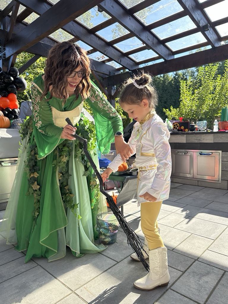 Child playing a Halloween-themed game with a costumed entertainer