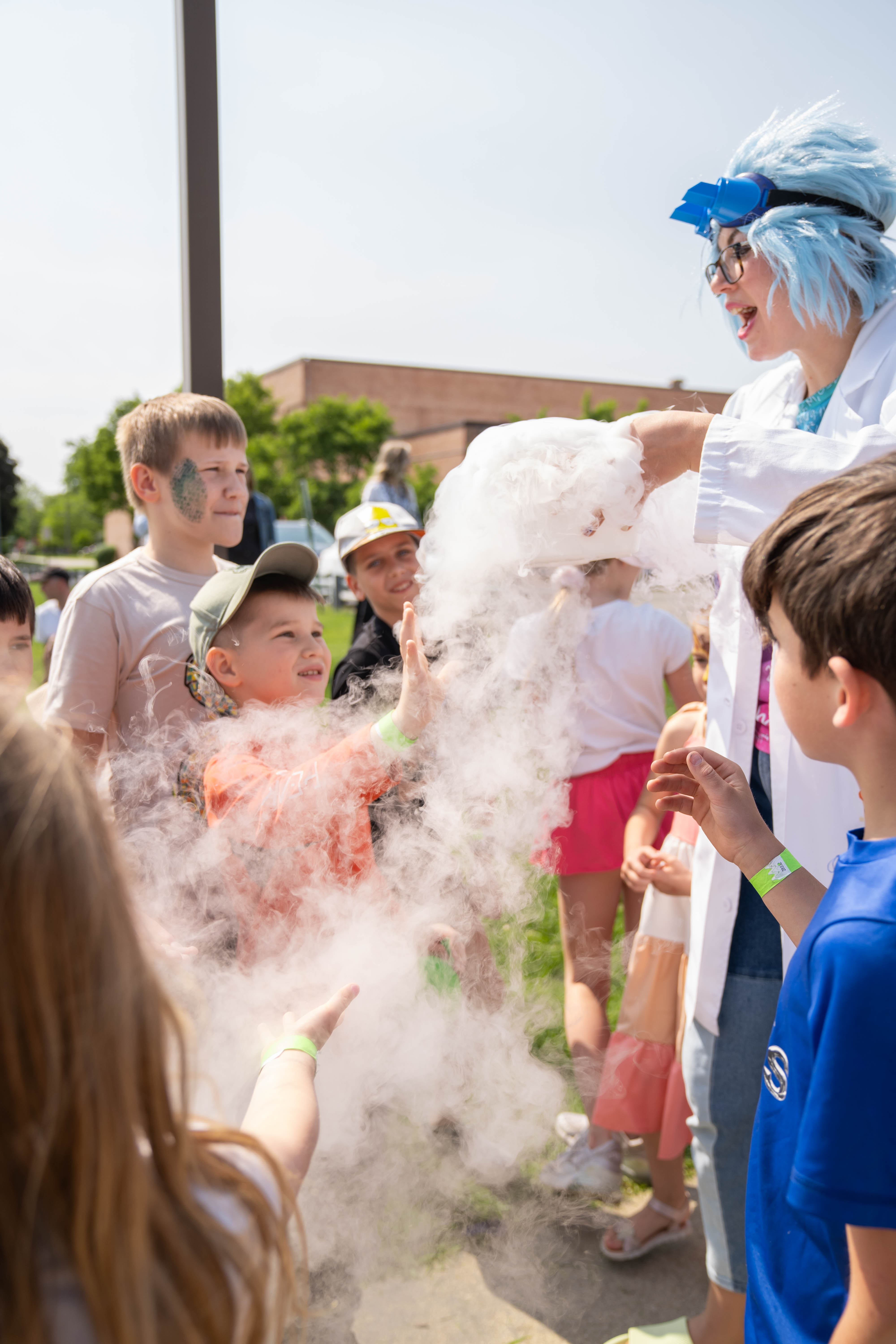 Children enjoying a science experiment with fog at a kids event